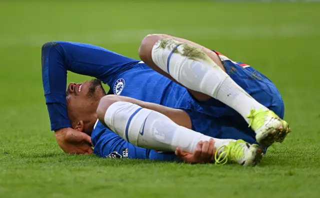 Joao Pedro lays on the turf injured
