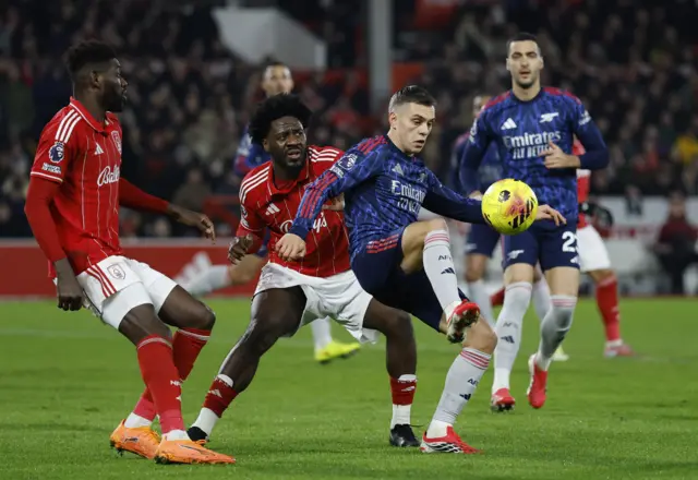 Arsenal's Leandro Trossard in action with Nottingham Forest's Ola Aina and Ibrahim Sangare