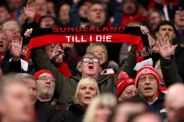 Sunderland holds up a scarf which reads "Sunderland Till I Die"