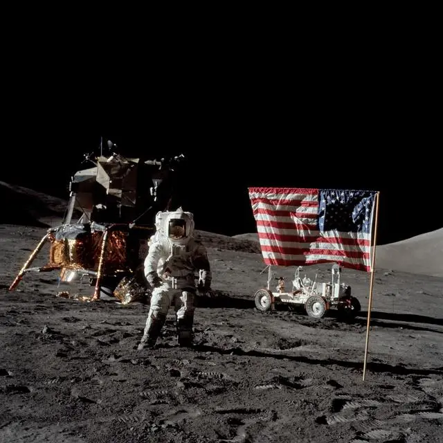 Astronaut Harrison Schmitt, Apollo 17 lunar module pilot, stands near the deployed United States flag on the lunar surface in 1972