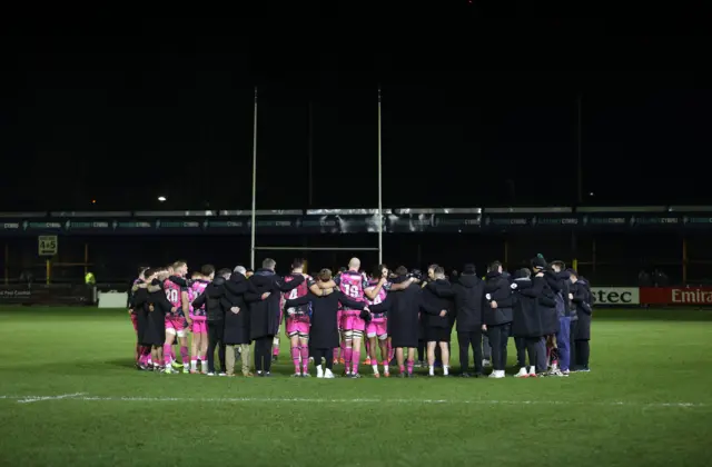 Ospreys huddle in the middle of the pitch
