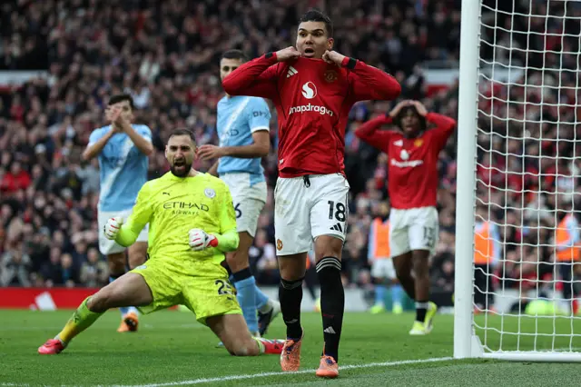 Manchester United's Brazilian midfielder #18 Casemiro (C) reacts to a missed chance as Manchester City's Italian goalkeeper #25 Gianluigi Donnarumma