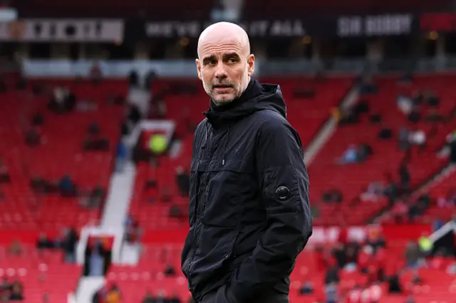 Pep Guardiola, Manager of Manchester City, inspects the pitch