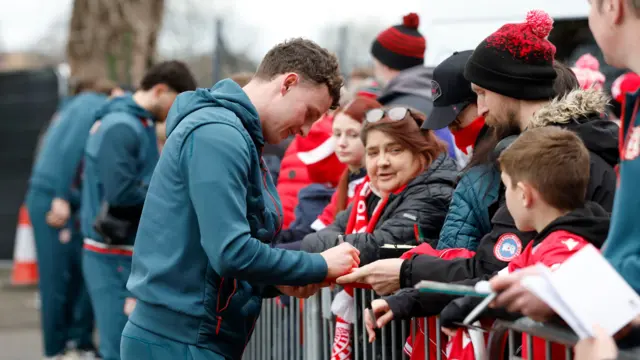 Wrexham's Nathan Broadhead signs autographs for supporters
