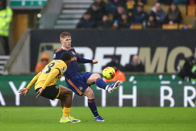 Lewis Hall of Newcastle United (3) controls the ball