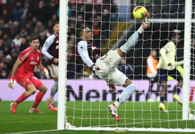 Everton's Thierno Barry scores their first goal as Aston Villa's Ezri Konsa attempts to clear the ball