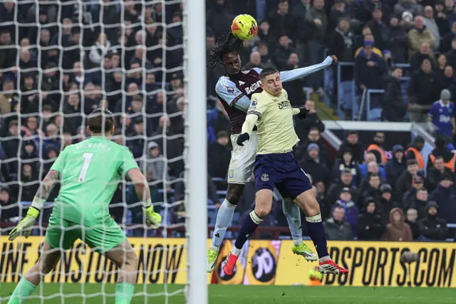 Evann Guessand (C) jumps for a header