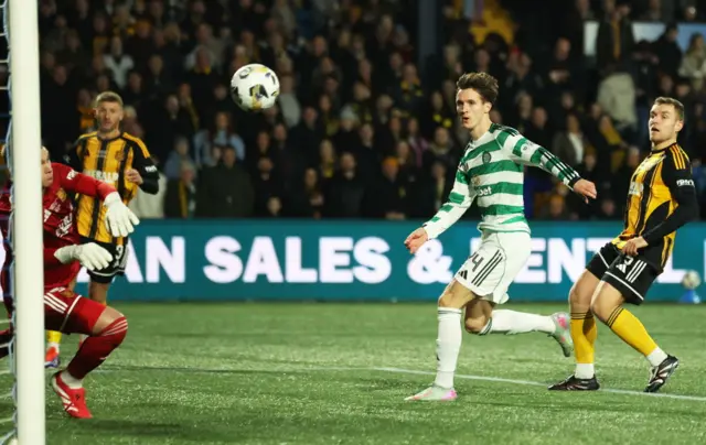Johnny Kenny's shot is saved by Wullie Muir
