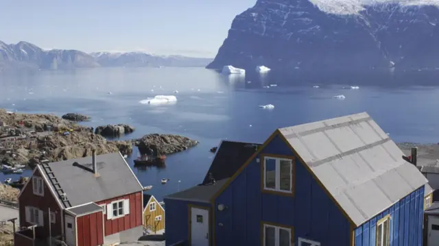 Wide shot of colourful houses on the coast of Uummannaq, one of Greenland's northernmost islands