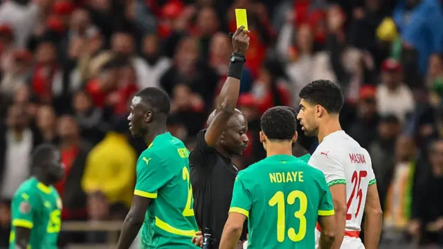 Jean-Jacques Ndala Ngambo gives a yellow card