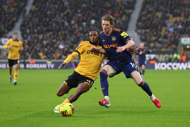 Jackson Tchatchoua of Wolverhampton Wanderers clashes with Anthony Gordon
