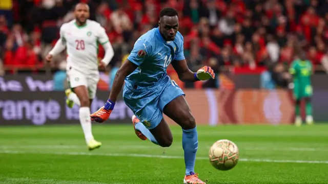 Edouard Mendy chases the ball