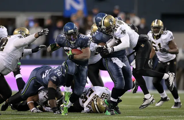 Marshawn Lynch makes a touchdown run against the New Orleans Saints in 2011