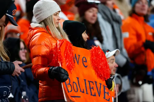 Denver Broncos fans hold sign saying "We Bolieve"