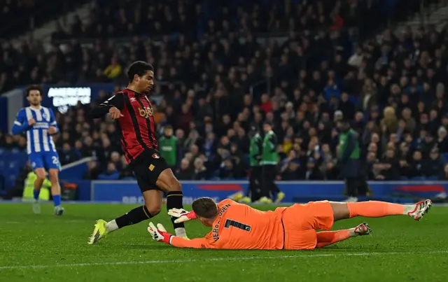 Brighton's Dutch goalkeeper #01 Bart Verbruggen dives to save from the feet of Bournemouth's Morrocan midfielder #21 Amine Adli,
