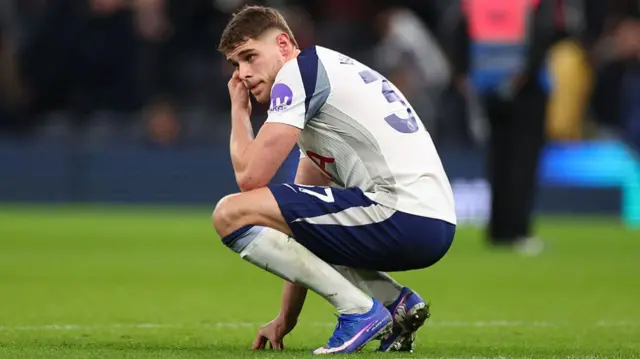 Micky van de Ven crouching down on the football pitch