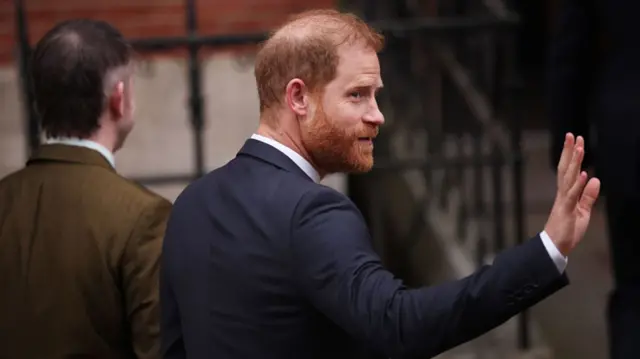 Prince Harry at court this morning. He's waving at cameras that are outside of the shot.