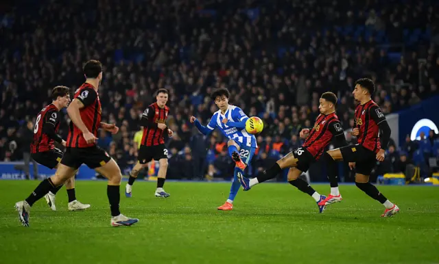 Kaoru Mitoma of Brighton & Hove Albion shoots wide whilst under pressure from Marcus Tavernier