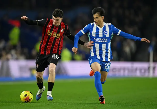 Alex Jimenez of AFC Bournemouth is challenged by Kaoru Mitoma