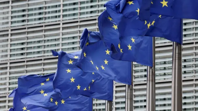 European Union flags flutter outside the EU Commission headquarters in Brussels
