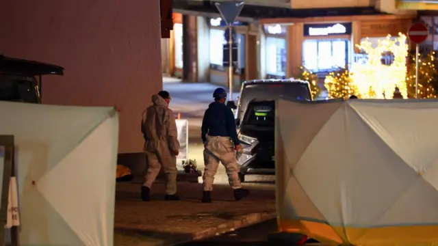 Emergency personnel work outside the "Le Constellation" bar,