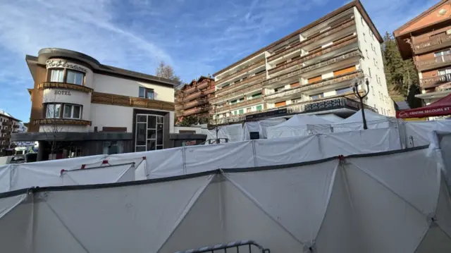 Temporary structures partially block the view buildings at the scene