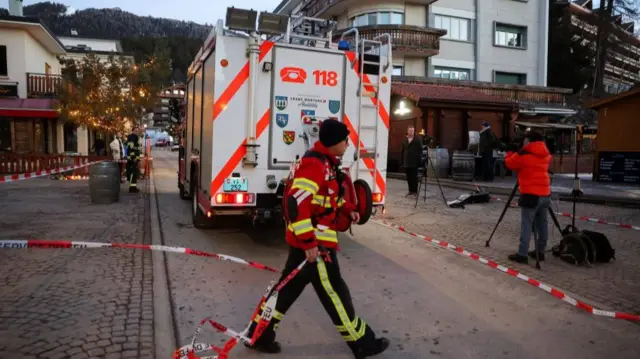 The area around the Le Constellation bar remains cordoned off - a firefighter is pictured at the scene on 2 January