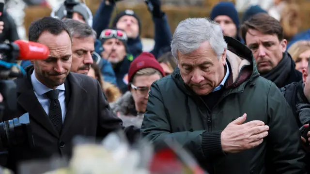 Italy's foreign minister Antonio Tajani reacts outside the Le Constellation bar