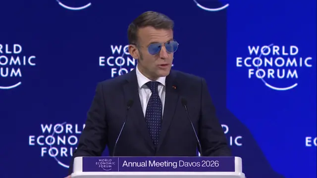 Macron wearing sunglasses speaking at Davos