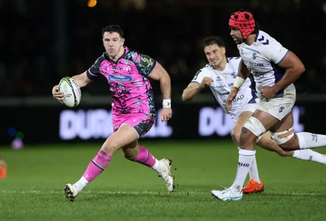 Owen Watkin runs with the ball for Ospreys