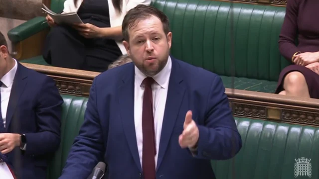 Stephen Doughty speaking in the House of Commons. He's wearing a blue suit and navy tie.
