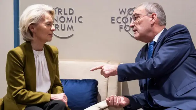 President of the European Commission Ursula von der Leyen (L) speaks with Switzerland's Federal President Guy Parmelin .