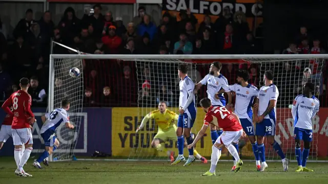 Luke Garbutt curls home a free-kick for Salford