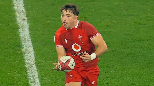 Wales fly-half Dan Edwards passes the ball