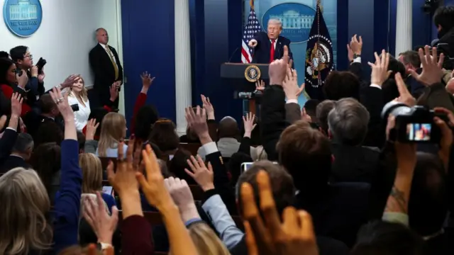 Donald Trump points to members of the media as he takes questions
