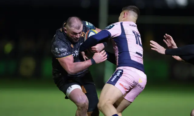 Ospreys' Sam Parry carries the ball into Cardiff's Callum Sheedy
