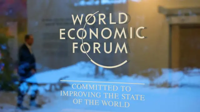 World Economic Forum logo on a glass door.