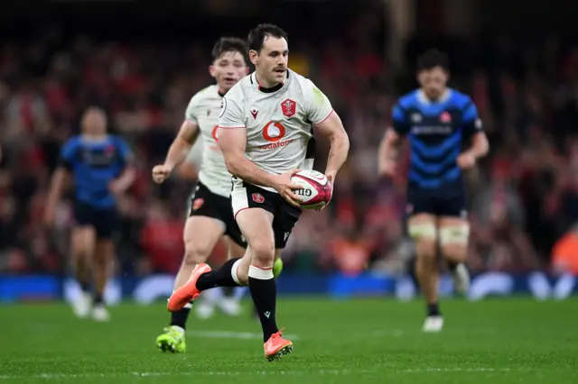 Tomos Williams runs with the ball for Wales