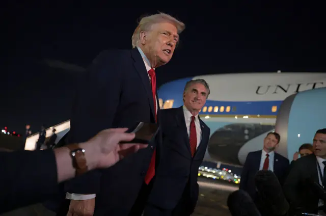 Trump with reporters, as Secretary of the Interior Doug Burgum (R) looks on, at Palm Beach International Airport in Florida