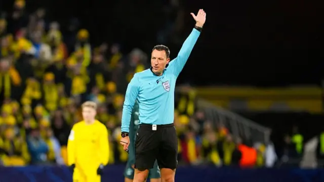 Referee raises his hand for offside
