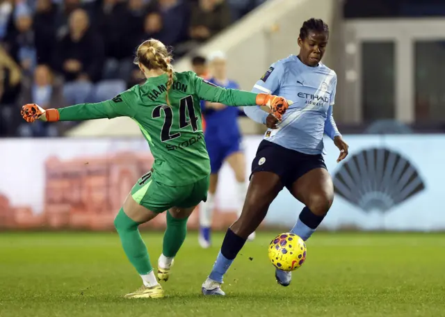 Chelsea's Hannah Hampton in action with Manchester City's Khadija Shaw