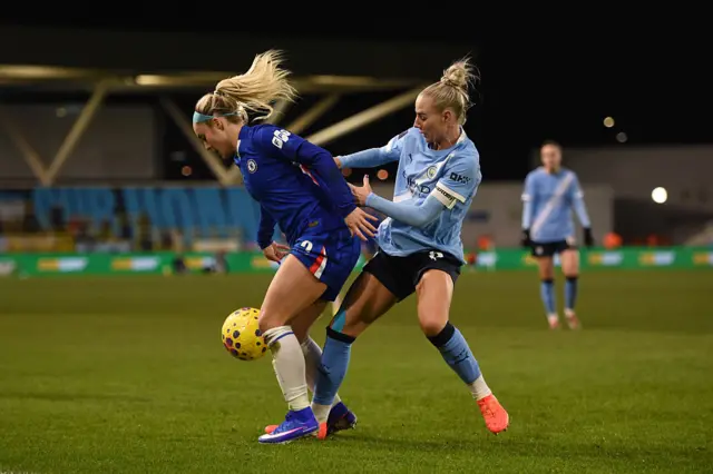Ellie Carpenter of Chelsea is challenged by Alex Greenwood of Manchester City