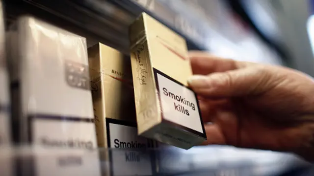 A cigarette pack is seen being purchased