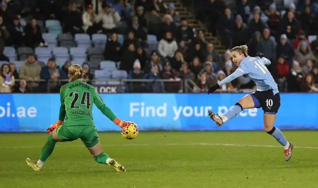 Vivianne Miedema of Manchester City shoots, as Hannah Hampton of Chelsea attempts to make the save