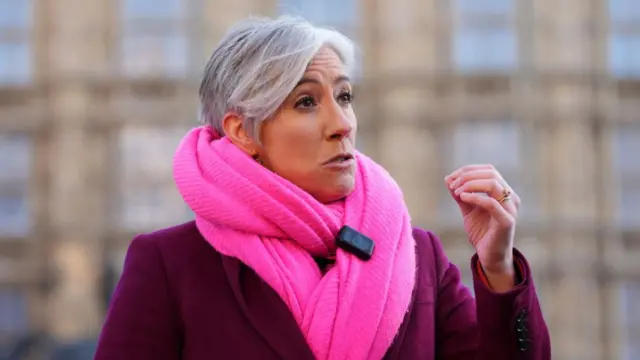 Liberal Democrat deputy leader Daisy Cooper. She is wearing a purple coat and a bright pink scarf