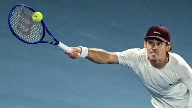 Alex De Minaur hits a forehand