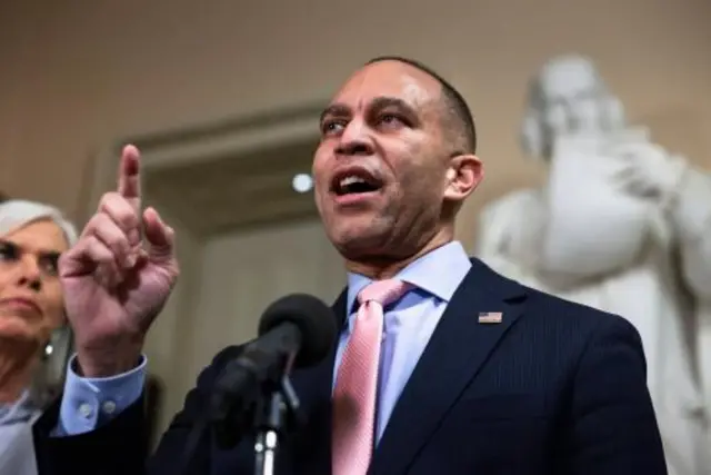 Rep Hakeem Jeffries points while addressing the press