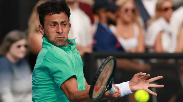 Emilio Nava hits a forehand