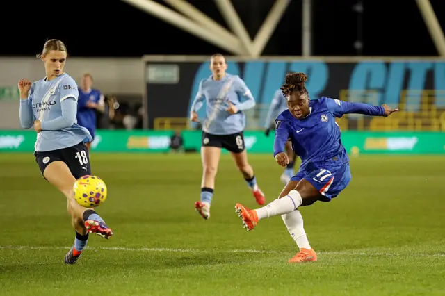 Sandy Baltimore of Chelsea shoots under pressure from Kerstin Casparij of Manchester City