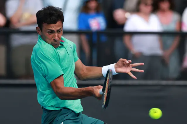 Emilio Nava hits a forehand